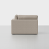 A side view of a modern, light beige sofa with clean lines and plush cushions, set against a plain white background.