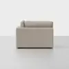 A side view of a modern, light beige sofa with clean lines and plush cushions, set against a plain white background.