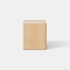 A modern wooden nightstand with a light finish, featuring a single open drawer and a minimalist design, sits on a plain, light-colored surface against a white background.