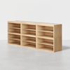 A rectangular wooden shelving unit with eight open compartments, arranged in two rows of four, standing on a smooth light gray floor against a plain white background.
