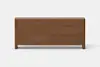 A modern wooden dresser with six drawers, finished in a medium brown color, shown against a plain white background.