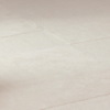 Close-up view of light beige tiles with smooth, matte surfaces and subtle grout lines forming a grid pattern. The lighting creates soft shadows and highlights the texture of the tiles.
