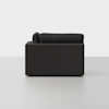Side view of a modern dark gray sofa with straight, clean lines and plush cushions, set against a plain light gray background.