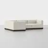 A modern, L-shaped sectional sofa with light beige upholstery and a dark wood base, set on a plain white background.
