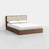 A modern wooden bed frame with a beige upholstered headboard, dressed in white bedding and pillows, set against a plain white background.
