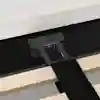 Close-up of a bed frame showing wooden slats, a central metal support beam attached to the frame with a bolt, and a black fabric strap laying across the slats. The beds upholstered edge is visible at the top.