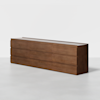 A long, modern wooden dresser with a smooth finish, featuring three rows of drawers and clean, minimalist lines, set against a plain white background.