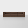 A modern brown three-seat sofa with blocky cushions and a light wood base, placed on a plain white floor against a white background.