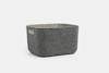 A gray felt storage basket with rounded corners and a rectangular cut-out handle on one side, placed against a plain white background.