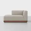 A modern lounge chair with light beige upholstery, a right-side backrest, and a low wooden base, set against a plain white background.
