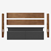 Disassembled bed frame with wooden components and a dark gray upholstered headboard, laid out neatly on a white background.