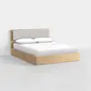 A modern wooden bed frame with a light wood finish, featuring a cushioned gray headboard and neatly made with white bedding and two pillows, set against a plain white background.