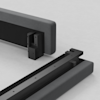 Two upholstered bed frame sections, shown close-up on a light surface, feature exposed black metal brackets and connectors designed to join the two pieces together.