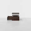 A modern dark wood storage box with one open drawer and a separate top lid floating above it, set against a plain white background.