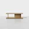 A minimalist wooden coffee table with a rectangular top, open sides, and a central vertical panel, set against a plain white background.