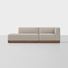 A modern, light beige sectional sofa with a wooden base, featuring a left chaise and right armrest, set against a plain white background.