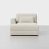 A modern, light beige upholstered chaise lounge with a single left armrest and matching rectangular cushion, set against a plain white background.