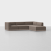 A modern, L-shaped sectional sofa with brown upholstery, low-profile back and armrests, set on a light grey floor against a plain white background.
