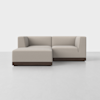 A modern beige sectional sofa with clean lines and dark wooden base, set against a plain white background. The sofa has a left-side chaise lounge and right-arm loveseat configuration.