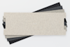 Four rectangular sheets of textured paper or cardboard in varying shades of gray and black, stacked and slightly fanned out on a white background.