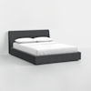 A modern, low-profile bed with a dark gray upholstered frame and headboard, neatly made with white sheets, two white pillows, and a white duvet, set against a plain white background.