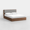 A modern wooden bed with a light gray upholstered headboard, neatly made with white bedding and two white pillows, set against a plain white background.