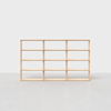 A wooden shelving unit with twelve open rectangular compartments, arranged in three rows and four columns, standing on a smooth, light gray floor against a plain white background.