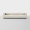 A modern, three-seat sofa with light beige upholstery and a wooden base, set against a plain white background.