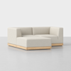 A modern, L-shaped sectional sofa with light beige upholstery and a wooden base, placed on a smooth, light-gray floor against a plain white background.