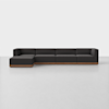 A modern, dark gray sectional sofa with a left-facing chaise and low wood base sits on a light gray floor against a plain white background.