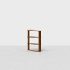 A small, minimalist wooden bookshelf with four shelves stands alone on a light gray floor against a plain white background.