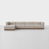 Modern beige sectional sofa with clean lines, low backrests, and a wooden base, set against a plain white background on a light-colored floor.