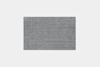 A square, flat, grey rug with a subtle textured pattern is shown on a plain white background.