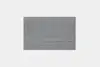 A square, flat, grey rug with a subtle textured pattern is shown on a plain white background.