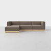 A modern sectional sofa with brown upholstery and light wooden base, featuring a left-side chaise lounge, set against a plain white background on a smooth light floor.
