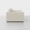 A modern, textured, off-white sofa viewed from the side, against a plain white background. The sofa has thick armrests and back cushions with a clean, minimalist design.