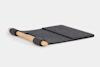 A dark gray felt desk mat with a built-in wooden roll at one end, designed to organize workspace items or support wrists, displayed on a white background.