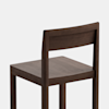 A simple, modern wooden chair with a flat seat, straight legs, and a rectangular backrest, shown against a plain white background.