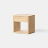 A minimalist wooden nightstand with a single drawer and an open shelf below, set against a plain white background.