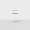 A minimalist, four-tier wooden bookshelf standing on a light gray floor against a plain white background. The shelf has an open design with no items on it.