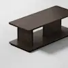 A modern, rectangular dark wood coffee table with a solid top and base, connected by two wide vertical supports, placed on a light-colored surface.