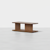 A modern, rectangular wooden coffee table with a flat top, two wide vertical supports, and a solid base, set against a plain white background.