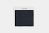 A square black textured fabric swatch is displayed on a white background with a white card above it labeled THUMA in black uppercase letters.