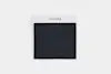 A square black textured fabric swatch is displayed on a white background with a white card above it labeled THUMA in black uppercase letters.