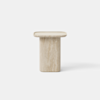 Minimalist, light beige stone side table with a cylindrical base and a flat, square top, set against a plain white background.