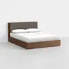 A modern wooden bed with a brown upholstered headboard, white bedding, and two pillows, placed in a minimalistic room with a light gray floor and white walls.
