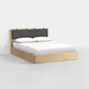A modern wooden bed frame with a light finish, featuring a dark gray cushioned headboard and white bedding with two pillows, set against a plain white background.