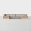 A modern, light gray sectional sofa with clean lines and a low wooden base sits on a smooth, light floor against a plain white background.