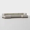 A modern, light beige sectional sofa with a low wooden base, arranged in an L-shape, set against a plain white background.