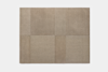 A square arrangement of eight rectangular beige carpet tiles, each with a slightly different texture and shade, forming a simple, geometric pattern on a plain white background.